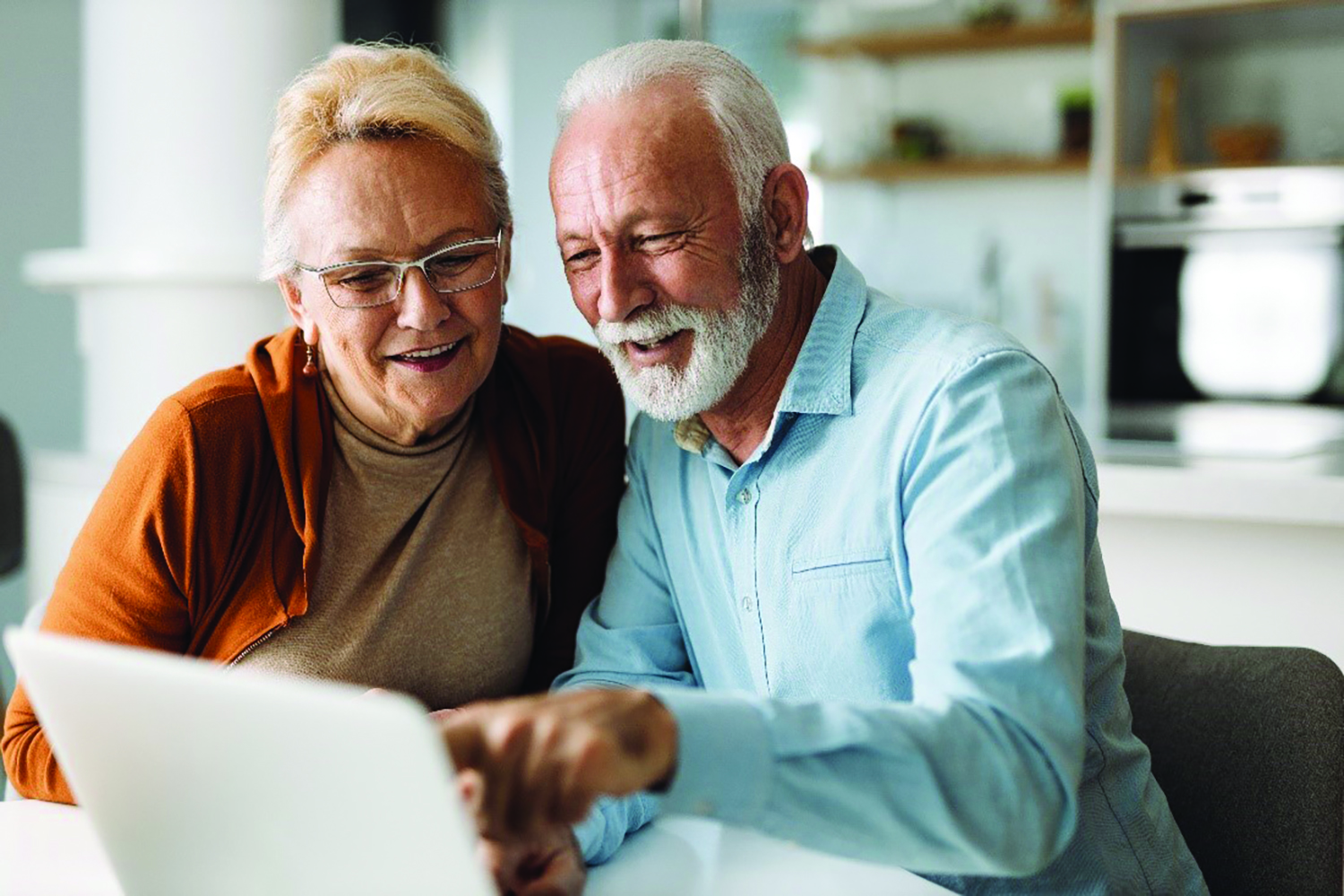 Older Couple Looking at a Laptop Smiling 8211 CMYK 300dpi